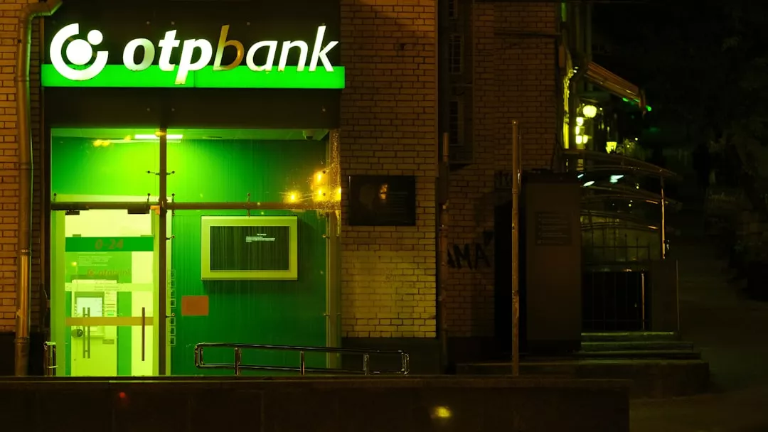 OTP bank branch at night with illuminated sign