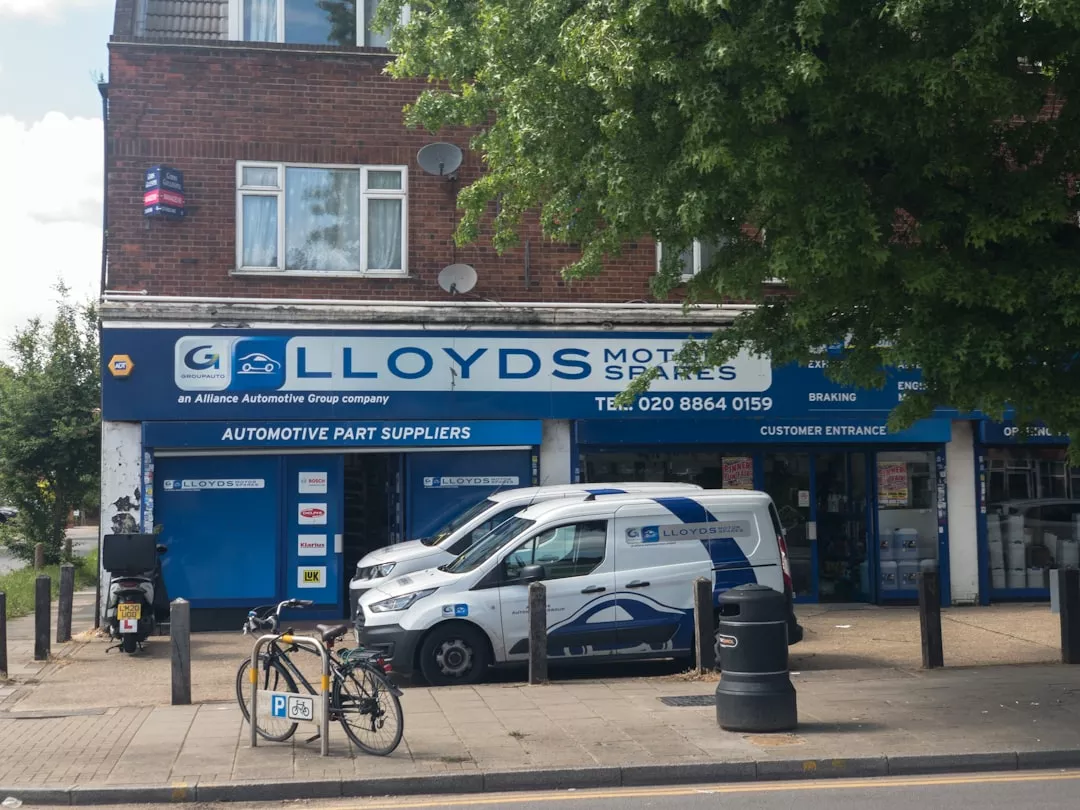 a blue and white van parked in front of a store